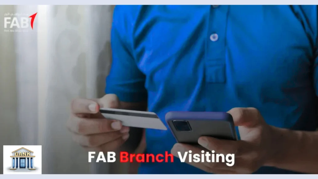 Person holding bank card and smartphone for FAB Branch Visiting and account management services.