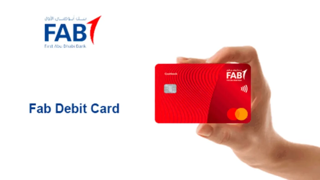 Hand holding FAB red debit card with Mastercard logo and contactless payment icon