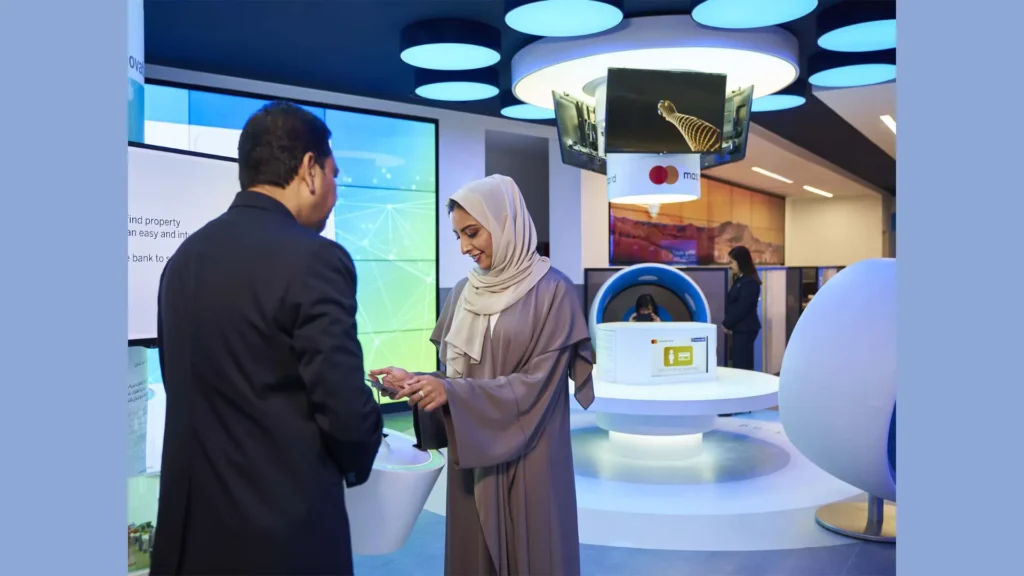 Emirates NBD branch staff assisting customer with banking services in a modern UAE customer support center
